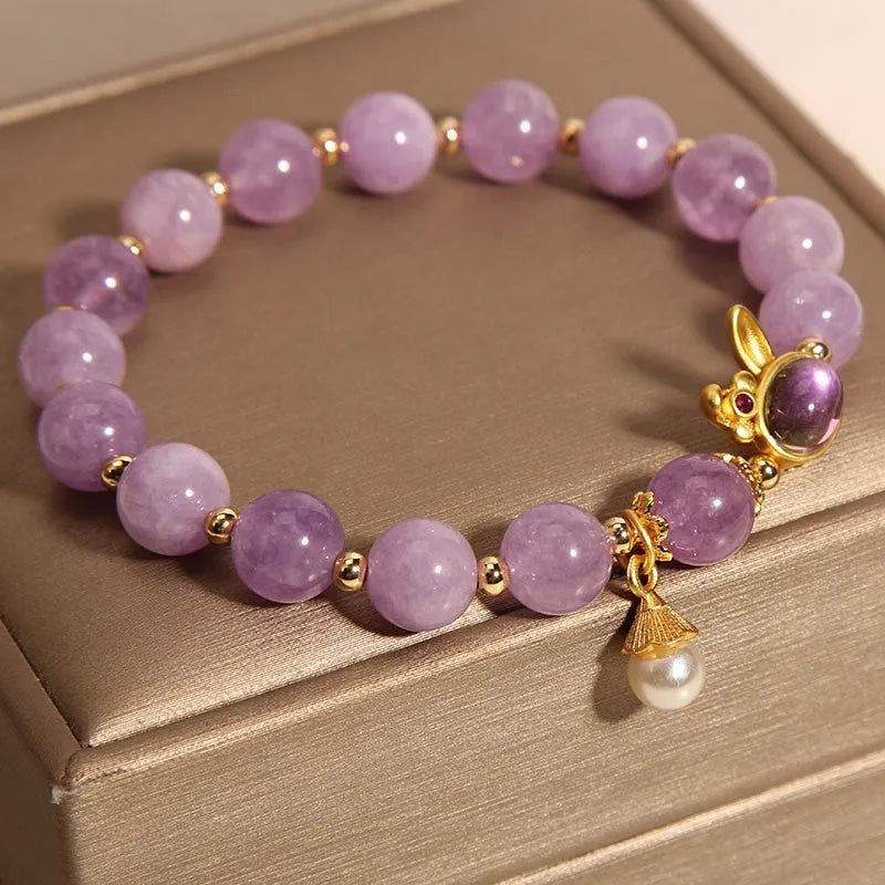 Natural mauve jade rabbit bracelet with crystal band and purplish red hare head charm.
