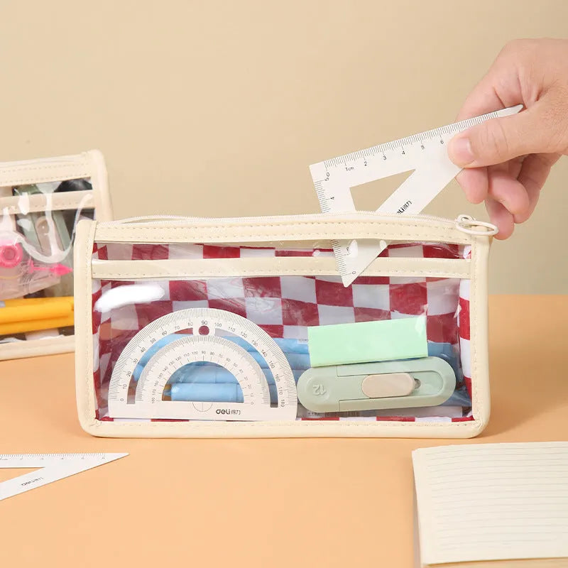 Transparent PVC pencil case showing internal chessboard grid pattern, measuring 21.5cm long.