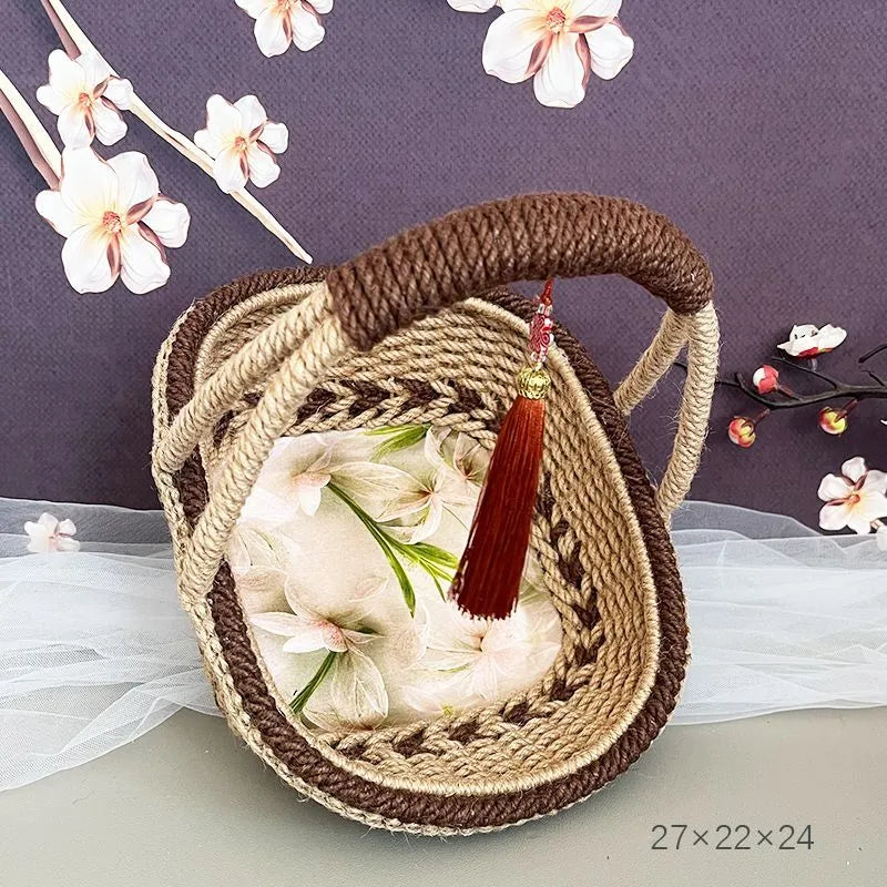 Coffee brown straw basket with hand-woven hemp rope detailing, shown on a wooden table.