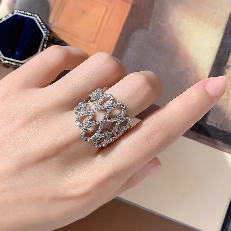 Women's gold plated copper ring with inlaid zircon stone and hexagon design on white background