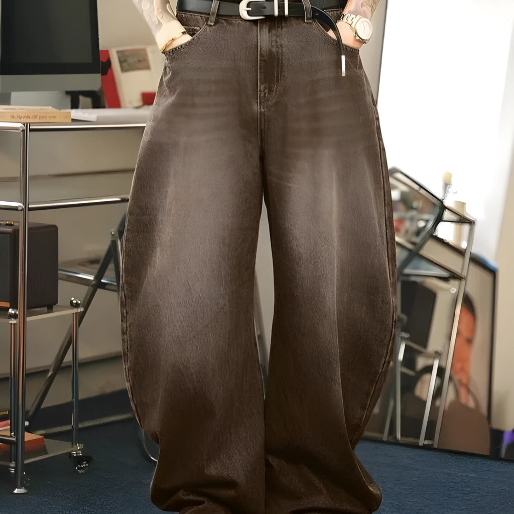 Men's brown washed loose flared jeans with low waist and zipper fly, side view