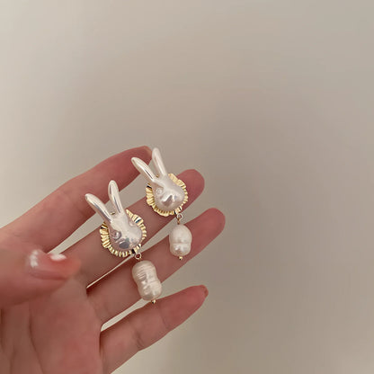 Silver bunny character earrings with baroque pearls measuring 2.5cm length with electroplated finish