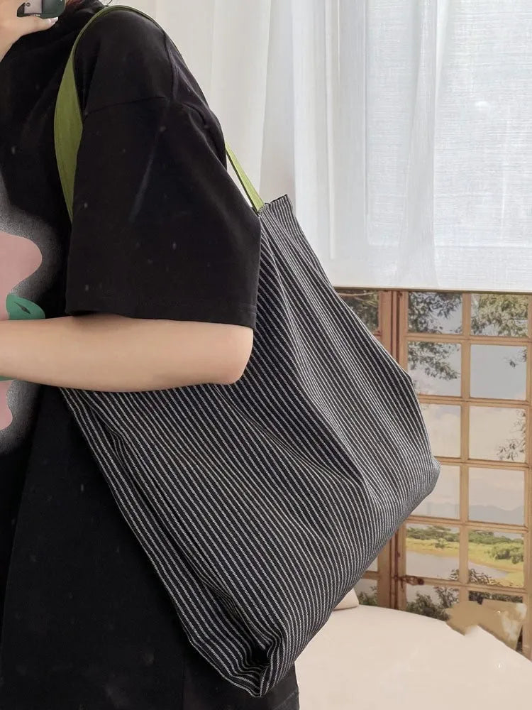 Canvas multi-layer tote shoulder bag showing three colour options: light pink stripes, black and gray plaid, dark gray stripes