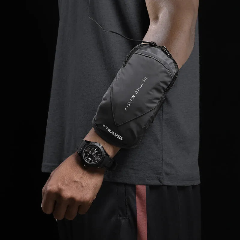 Reflective black running arm bag with adjustable strap shown on an arm.
