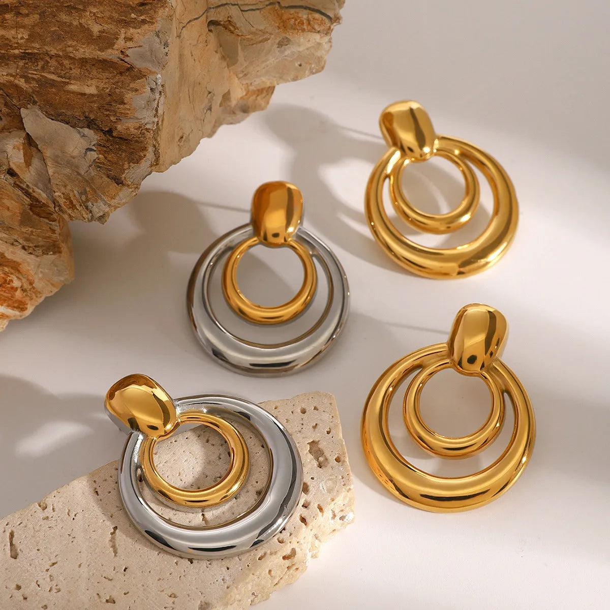 Round double layer hollow stud earrings with geometric design in electroplated 18K gold finish