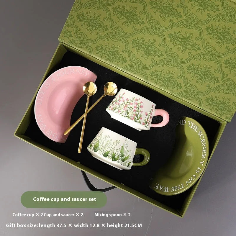 Ceramic coffee cup and saucer set with two mugs, plates, and spoons in couple designs