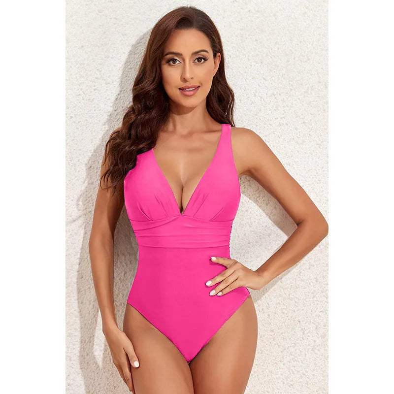 Women's solid colour cross shoulder one-piece swimsuit on a mannequin.