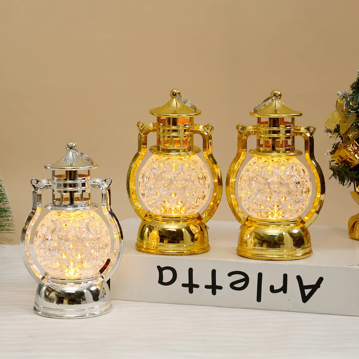 Creative retro-style oil lamp LED night light in gold or silver finish on a dark surface