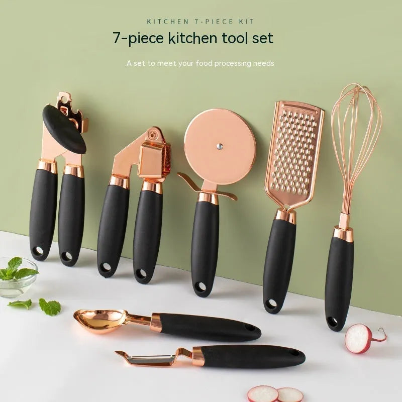 7-piece stainless steel kitchen tool set with copper plating in assorted colours on a countertop.