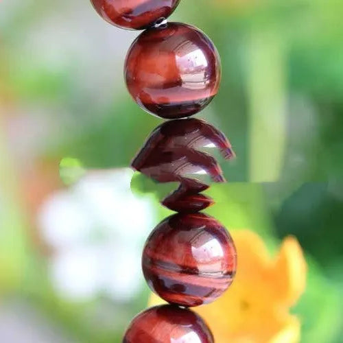 Red wood alexandrite bracelet with lightning cat's eye pattern and geometric beads