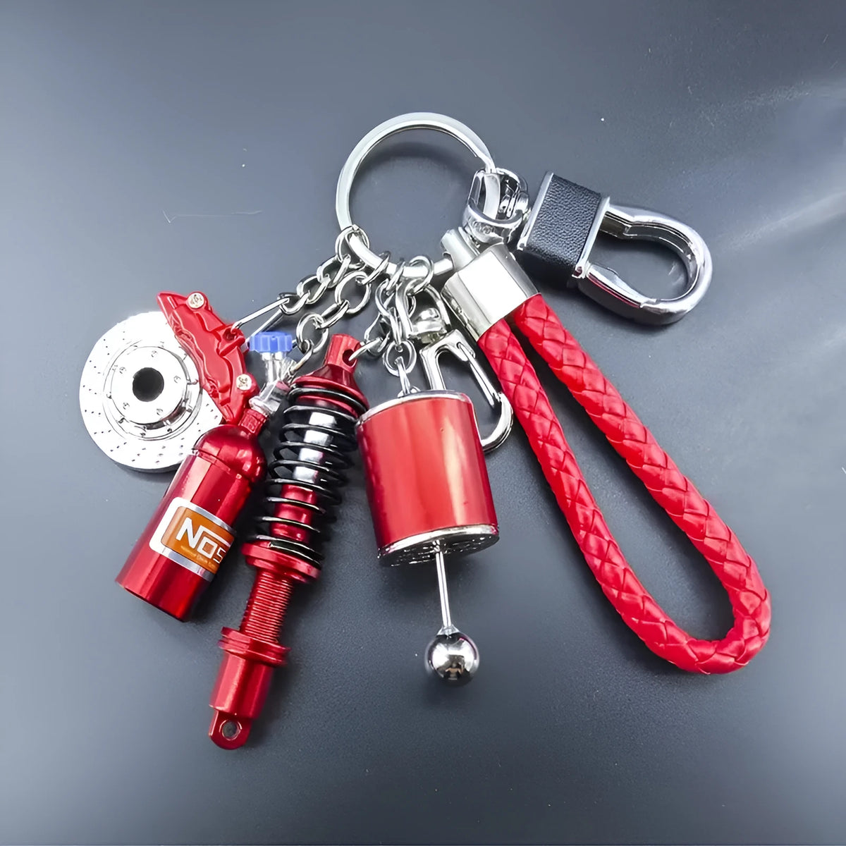 Set of four mini red zinc alloy keychains on a white background