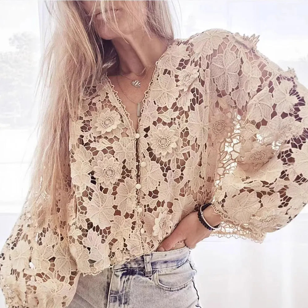 Loose fit white lace cardigan with black three-dimensional flower trim and a V-neck.