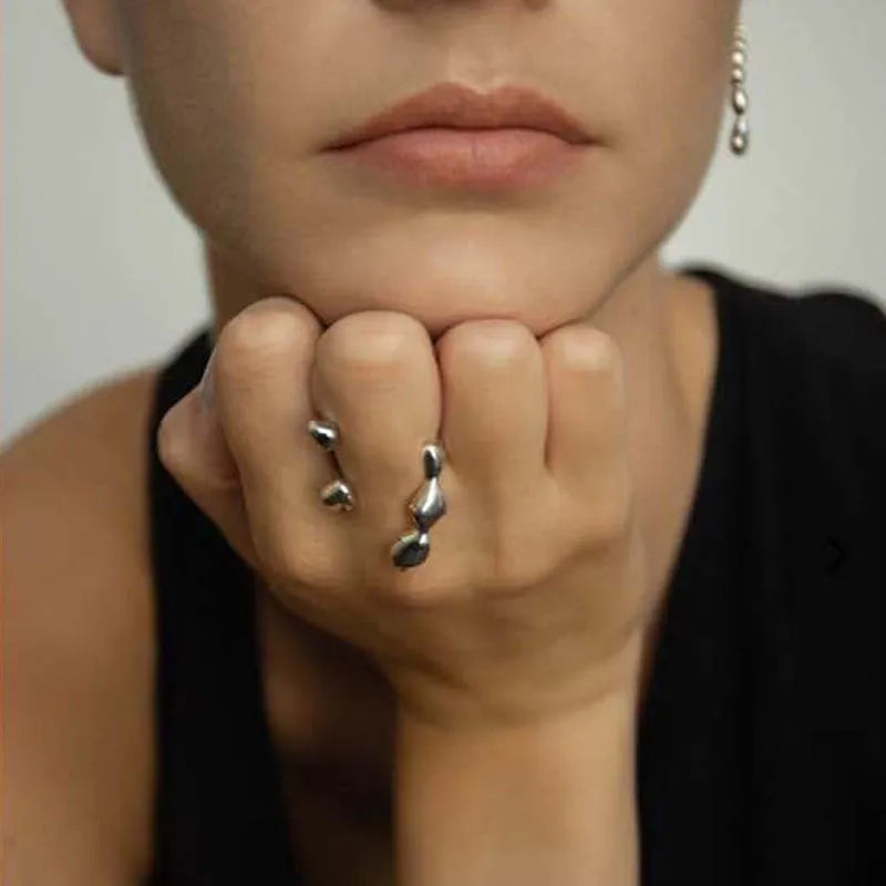 Gold and silver brass women's fashion ring with spherical design detail.