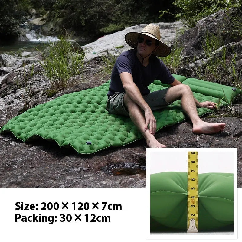Double-wide camping air mattress with integrated pillow in army green colour, shown inflated.