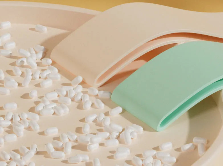 Colour-coded elastic resistance band showing pink, orange, beige, and green options for fitness and yoga