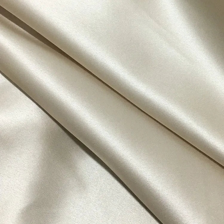 Dark grey mulberry silk pillowcase with envelope closure, shown in a modern bedroom setting.