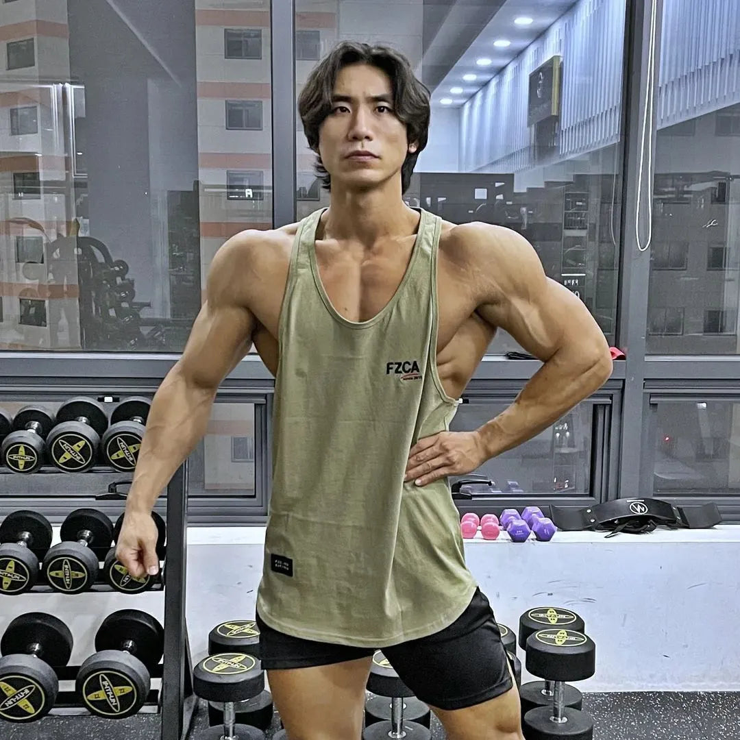 Men's white cotton sports vest for fitness and running training, shown on a hanger.