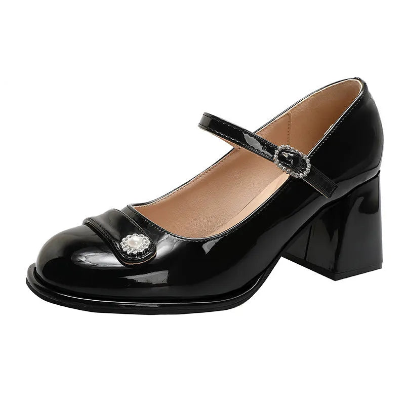 Women's black patent leather chunky heel court shoe with round toe and buckle fastening.