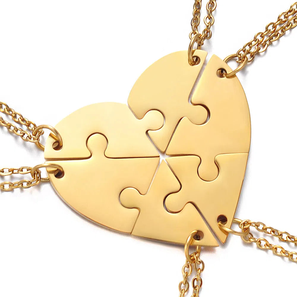 Stainless steel heart-shaped combination pendant necklace in gold finish on white background