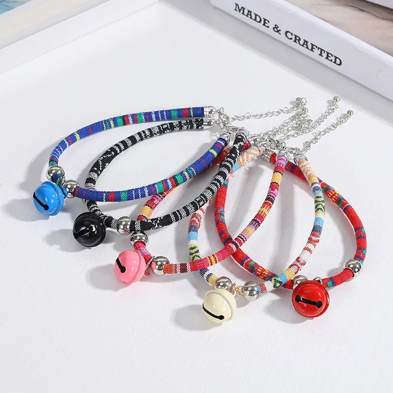 Ethnic pattern adjustable pet collar with bell attachment shown in multiple colour options