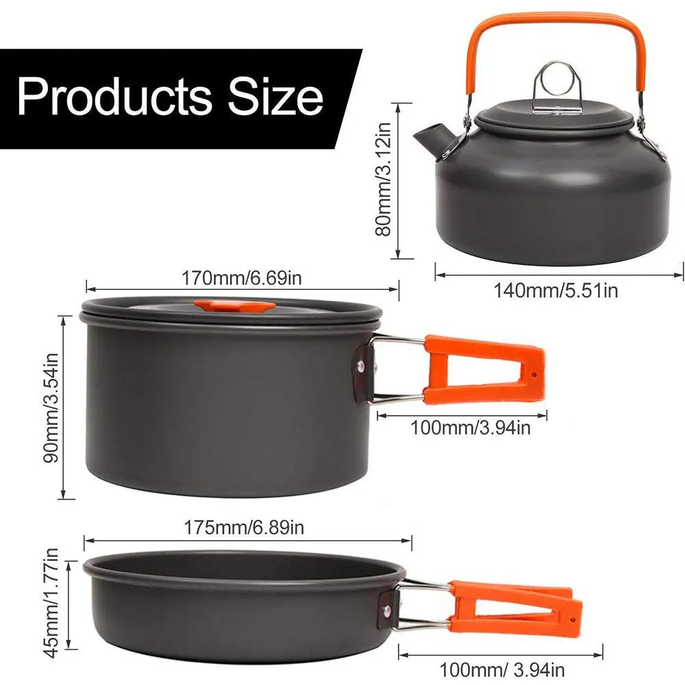 Orange folding camping cookware set with pots, pan, spoons, bowls in mesh bag on outdoor table