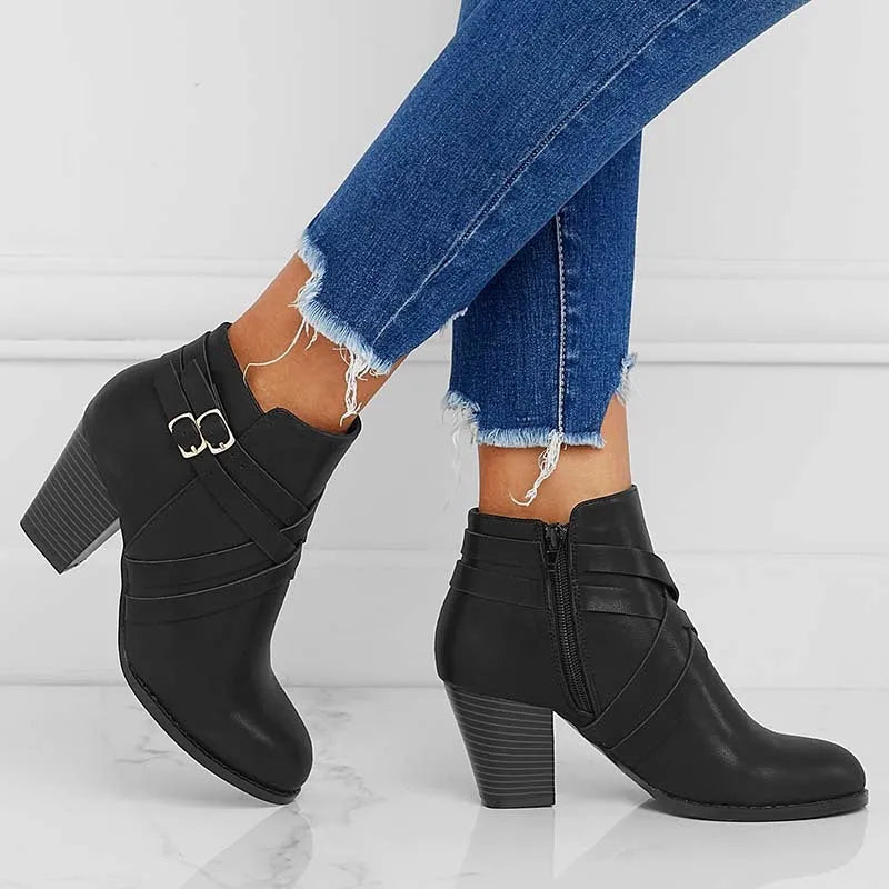 Women's grey ankle boot with 7cm block heel, side zipper, and buckle detail on a plain toe.