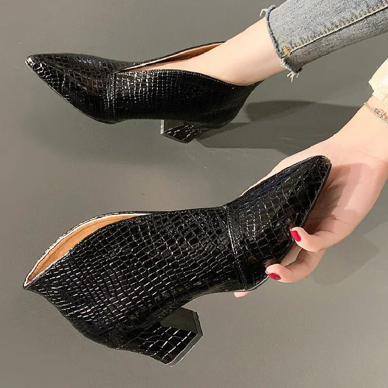 Women's black V-cut pointed toe ankle boots with embossed detail and a chunky block heel.