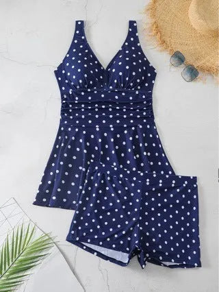 Blue polka dot print women's plus size bikini swimsuit on a hanger