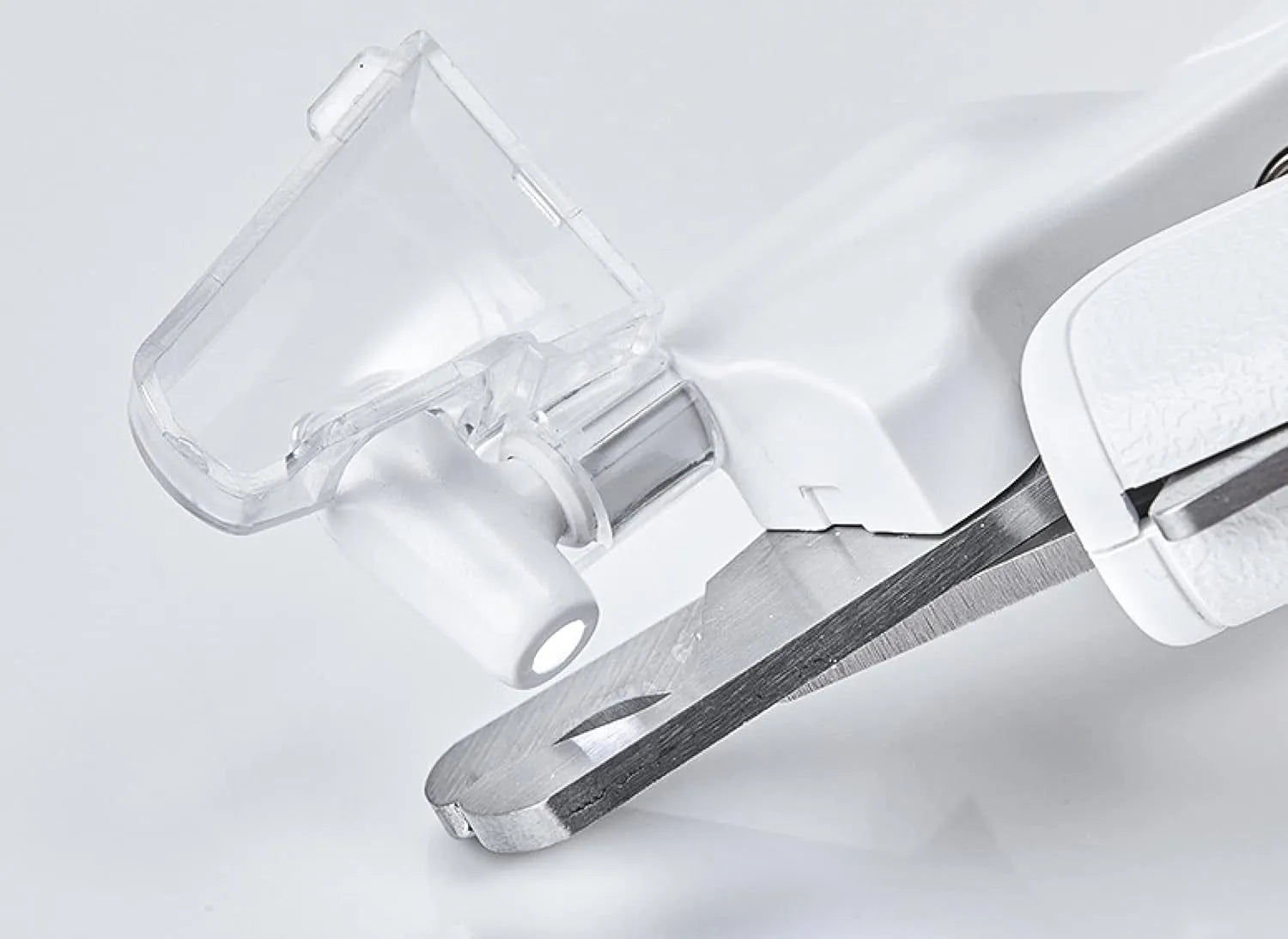 White pet nail clippers with LED light, transparent guard, and nail file on a grey background.