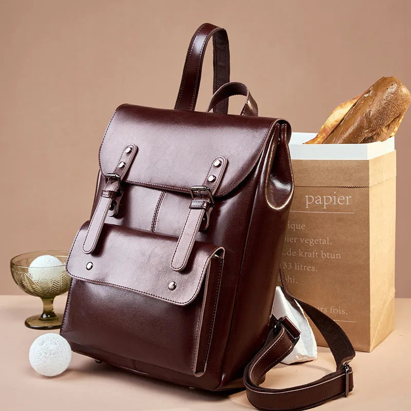 Women's structured backpack in genuine cowhide leather, shown in black, brown, and coffee colour options.