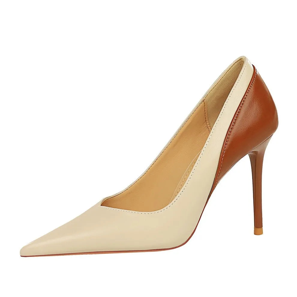Women's black retro pumps with a pointed toe and high stiletto heel on a white background.