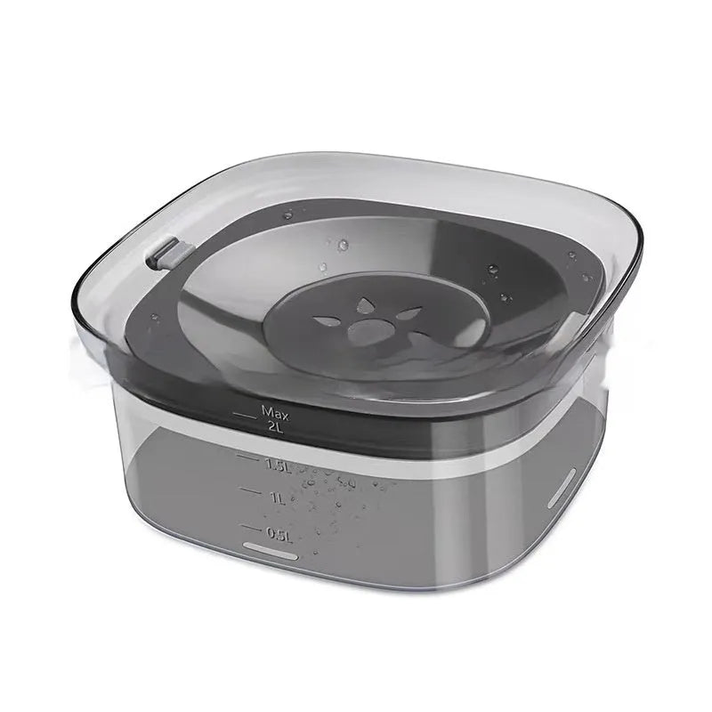 Transparent plastic dog water bowl with floating slow-feeder disk inside.