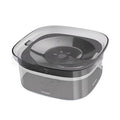 Transparent plastic dog water bowl with floating slow-feeder disk inside.