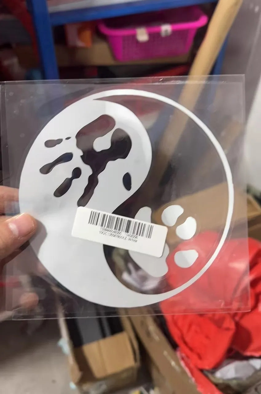 Yin yang vehicle sticker with cat and dog paw print design, 14cm square, self-adhesive, in black on a white background
