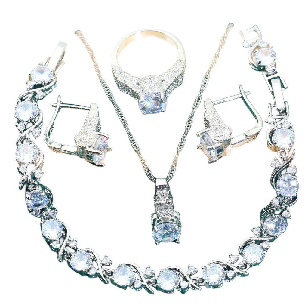 Bridal zircon four-piece jewellery set showing necklace, bracelet, earrings and ring with water wave chain design