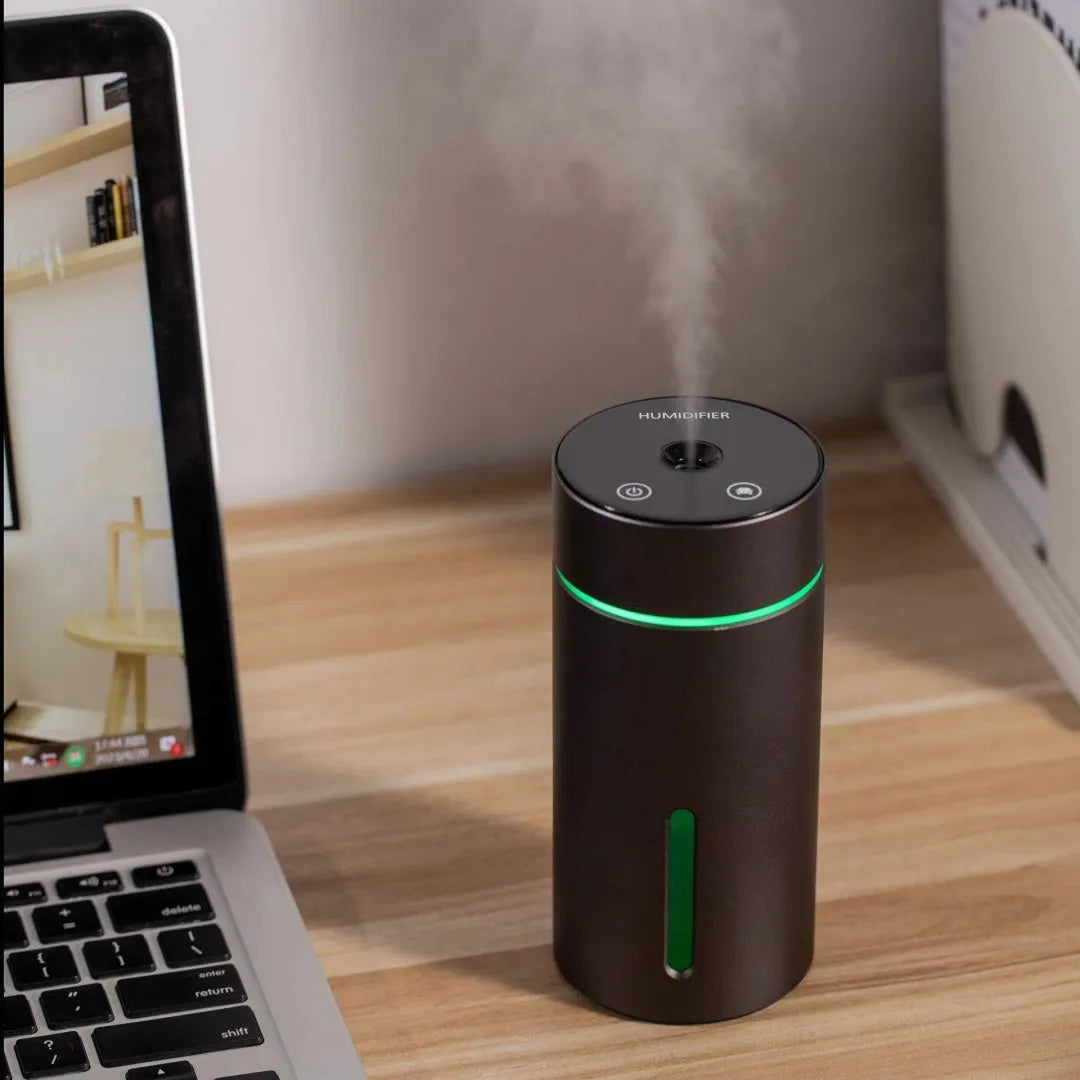 Aluminium portable car air humidifier and essential oil diffuser with coloured night light on.