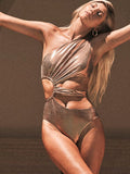 Gold women's one-piece swimsuit with backless design and spandex construction for swimming