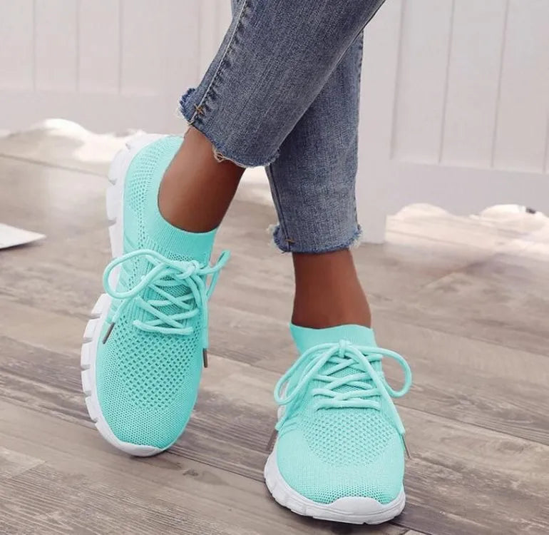 Women's high-cut lace-up sneaker in a choice of colours, showing breathable upper and flat rubber sole.