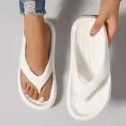 Women's black thick-soled EVA flip-flops with a non-slip patterned sole.