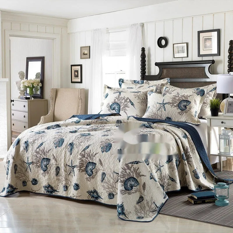 Quilted pure cotton bed cover and pillowcase set with printed pattern on a bed.