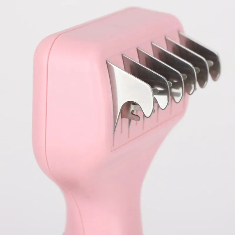 Pink dual-sided dog grooming comb with stainless steel blade and rotating ball-tip massage brush.