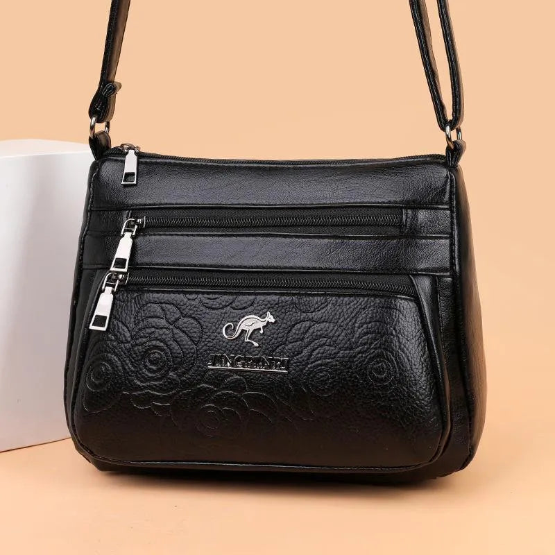 Women's black PU leather messenger bag with embossing and sewing thread details, horizontal square shape, single shoulder strap