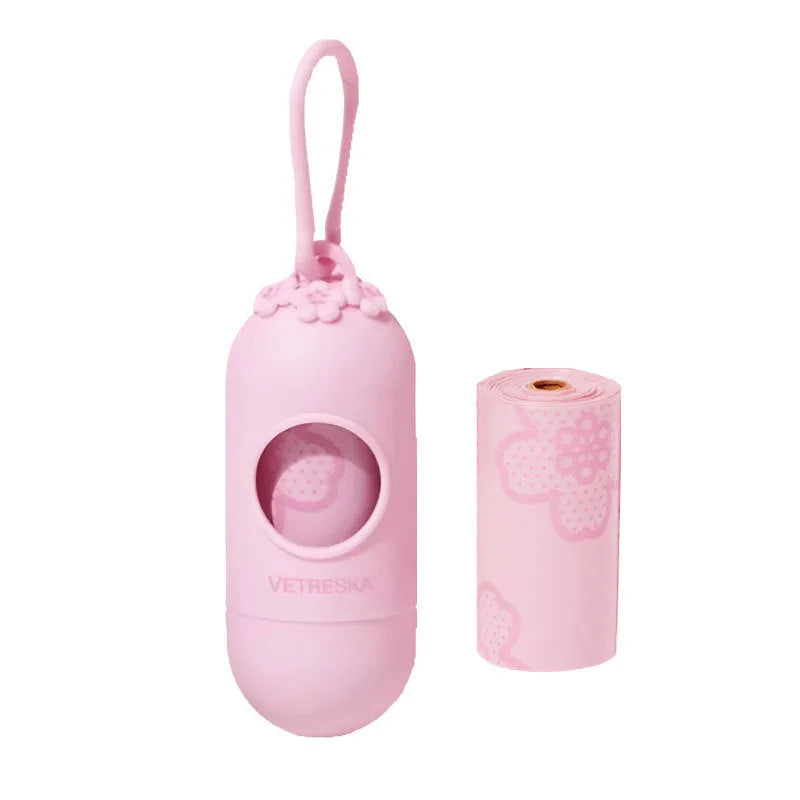Portable dog poo bag dispenser capsule in strawberry, orange, and cherry blossom designs with a roll of scented bags.
