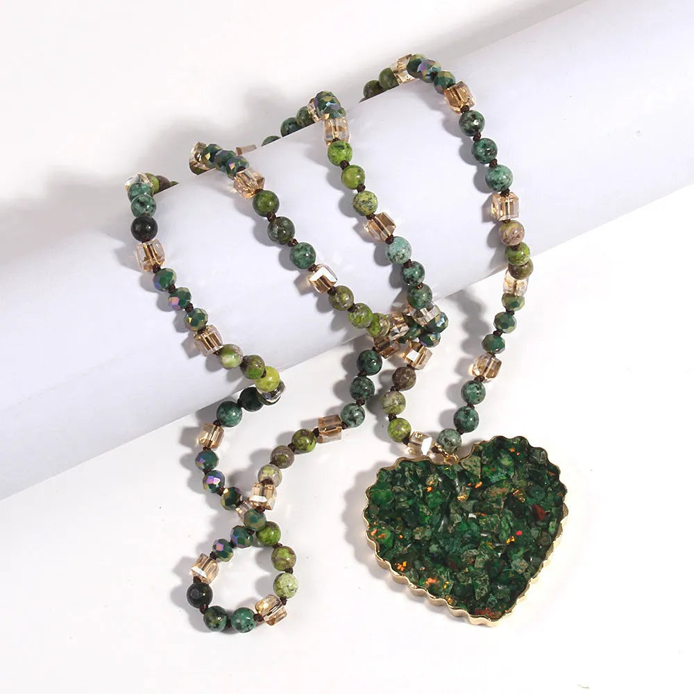 Bohemian style long chain heart pendant necklace in stone and glass with electroplated finish, available in multiple colours.