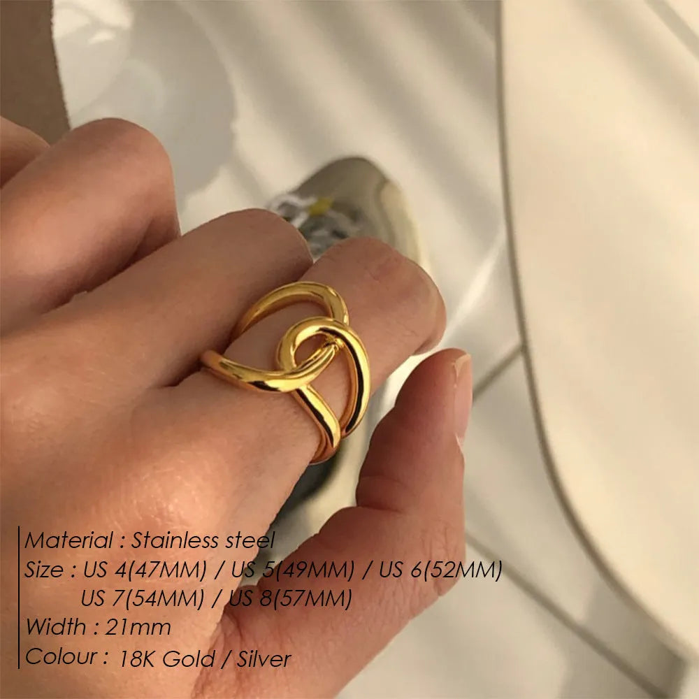 A stainless steel adjustable ring with a knotted detail on a U-shaped geometric band.