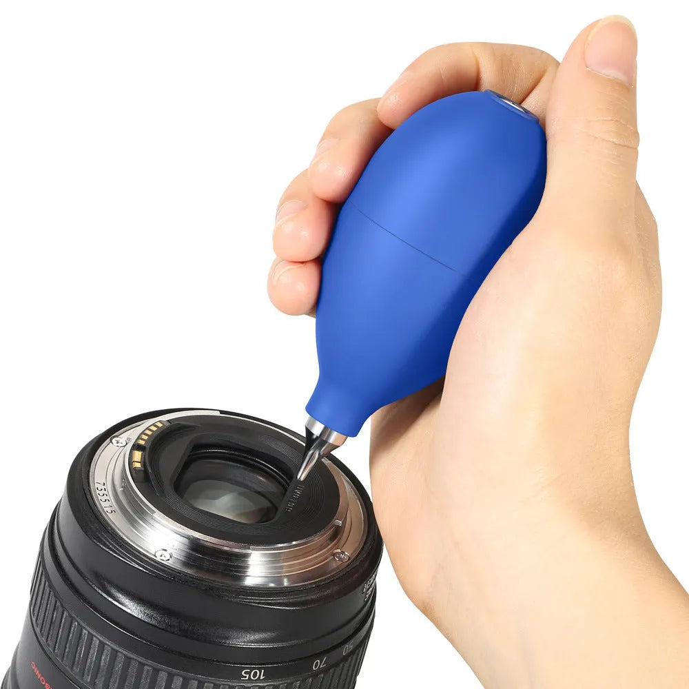 Blue rubber dust removal air blower cleaning tool shown next to a mobile phone.