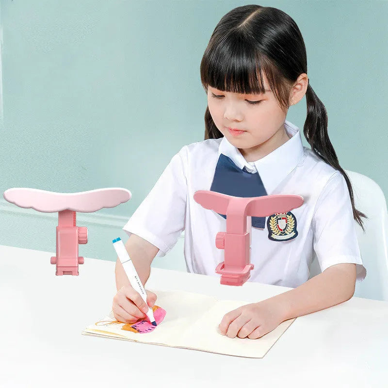 Student anti-myopia seated orthotics posture corrector with silicone chin support on a desk, blue frame