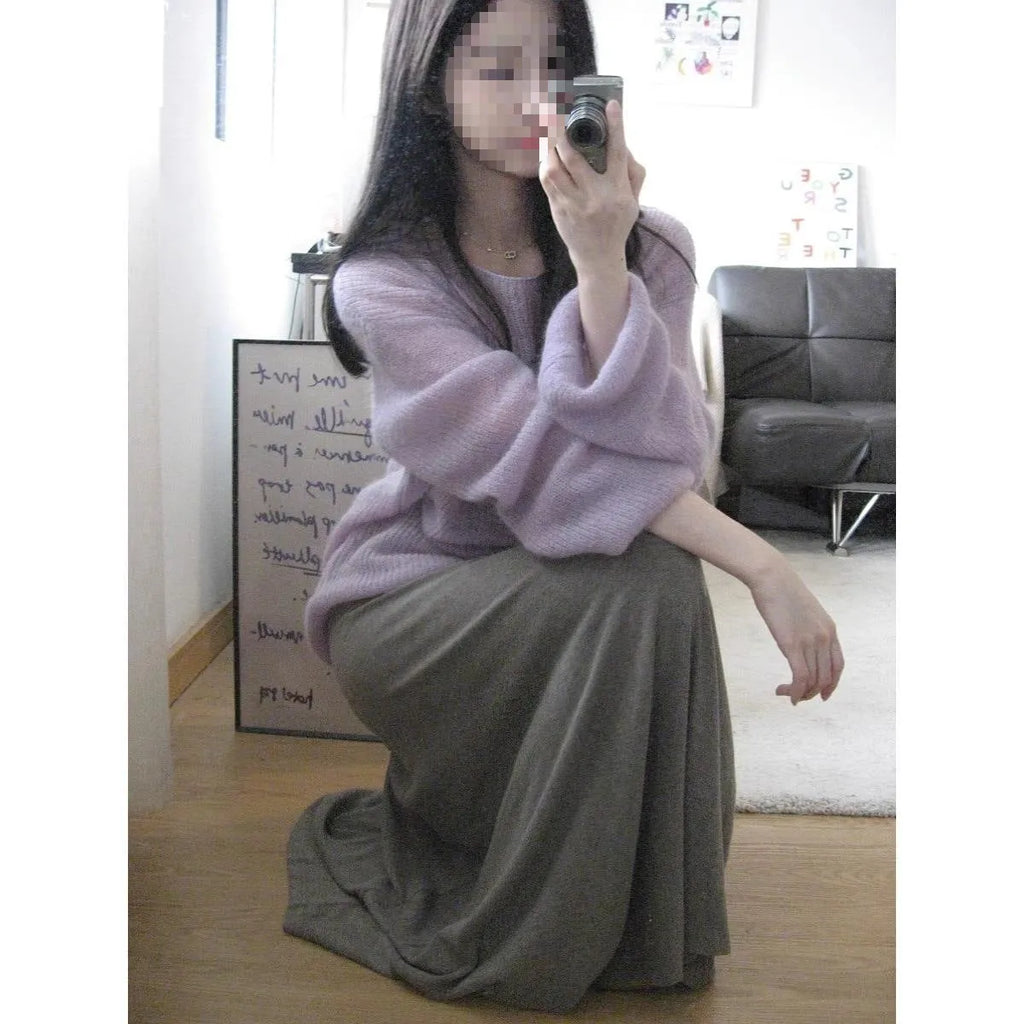 Purple women's sleeveless blouse with hollow out detail and princess sleeves, laid flat.