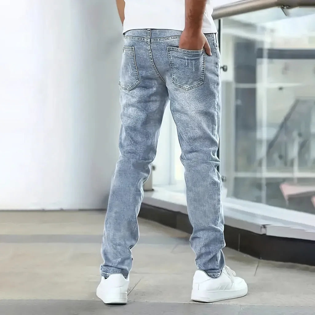 Men's black stretch jeans with straight leg and skinny opening, laid flat.