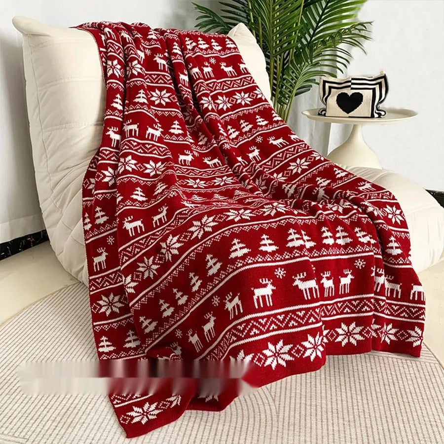 Personalised acrylic Christmas blanket with snowflake pattern draped over a sofa.